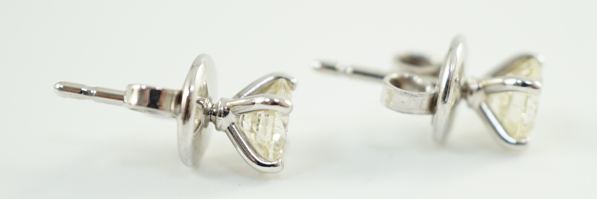 A pair of 18ct white gold and solitaire diamond set ear studs